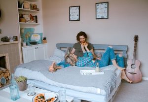 People in bedroom with 3 small succulent plants