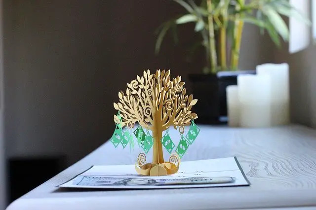 tree ornament with miniature money bills hanging
